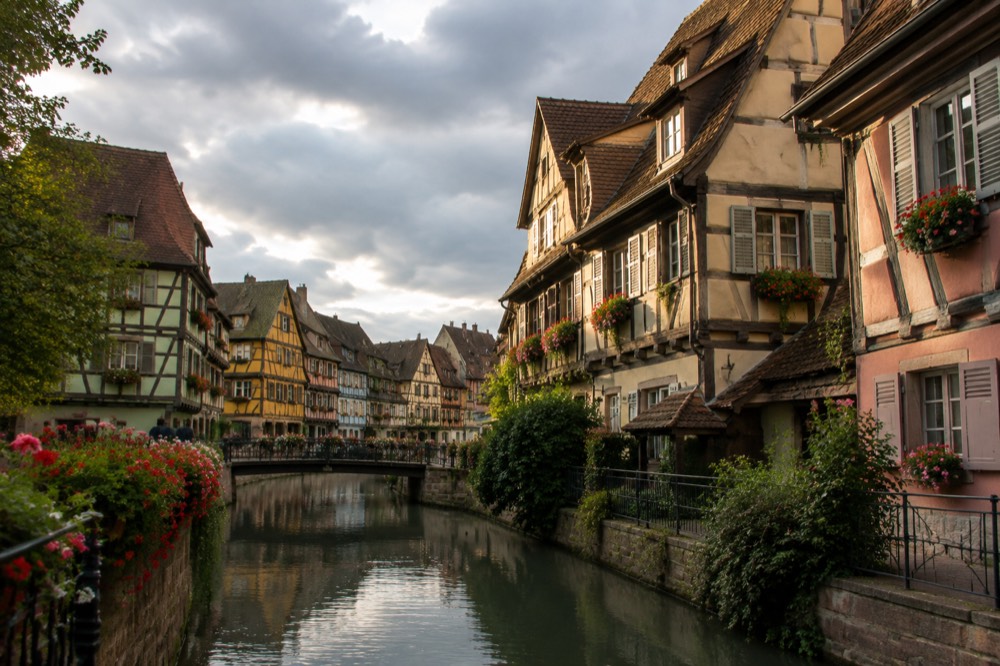Narrow street of leaning half-timbered houses in golden evening light