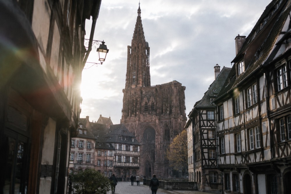 The single spire of Strasbourg Cathedral rising above the old city rooftops