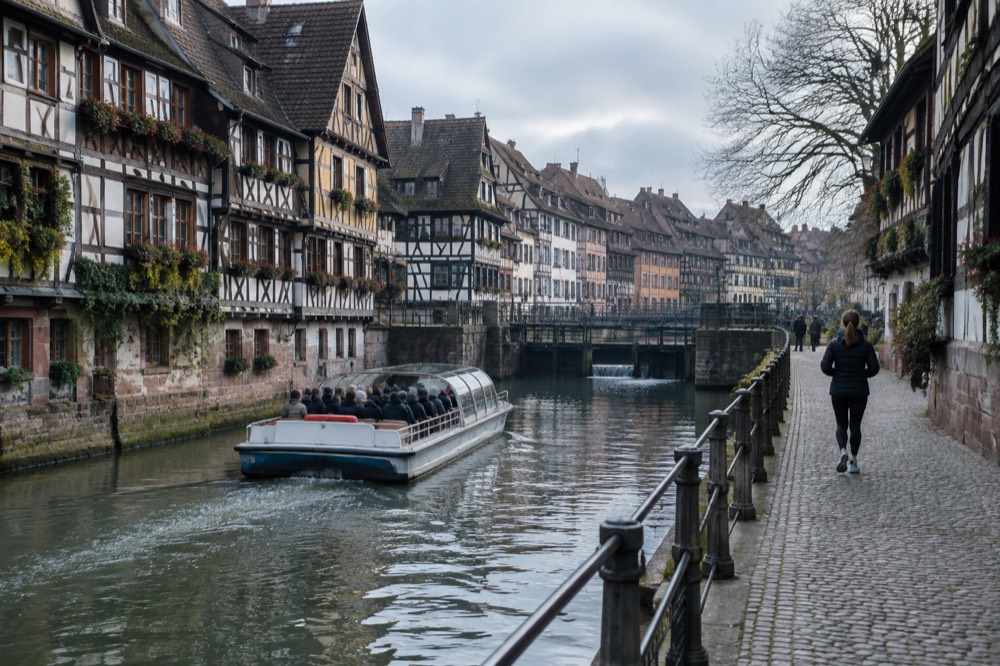 A family on a boat cruise passing the half-timbered houses of Petite France