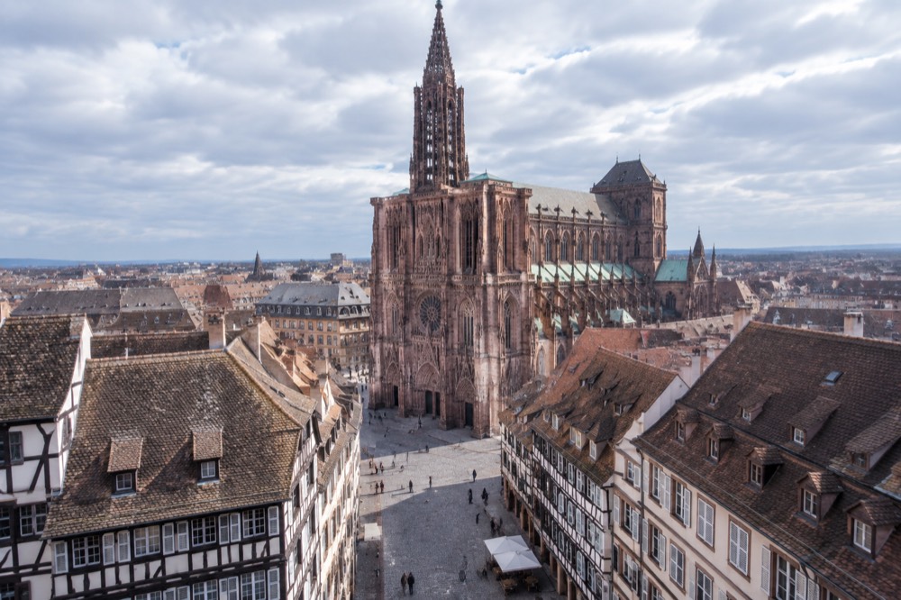 The single spire of Strasbourg Cathedral rising above rooftops of the old town