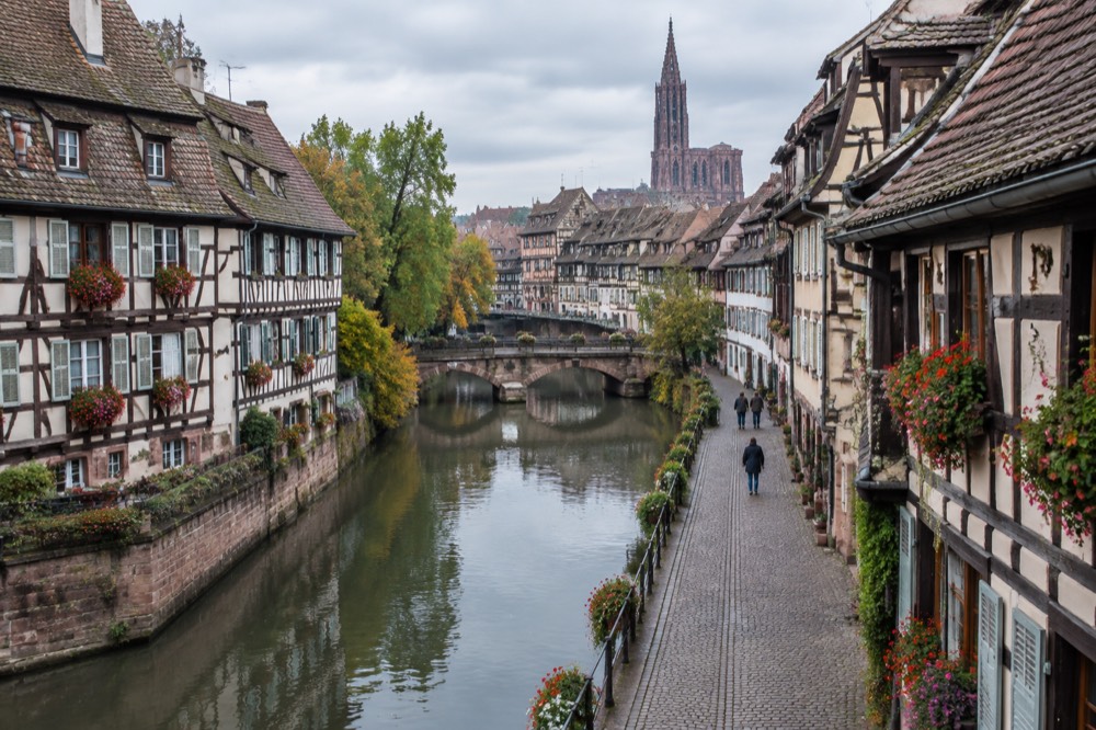 Flower-decorated half-timbered houses on a village street in the Alsace wine region
